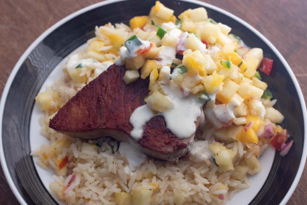 tuna steak cooked in pan w/ rice pineapple mango salsa