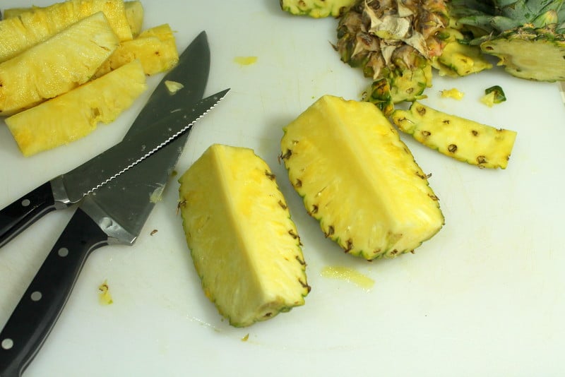 How to cut pineapple - Cut into quarters lengthwise - Real: The Kitchen and Beyond